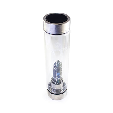 Gemini Laterra Gemstone Water Bottle with labradorite crystal attachment inside clear glass bottle on white background.